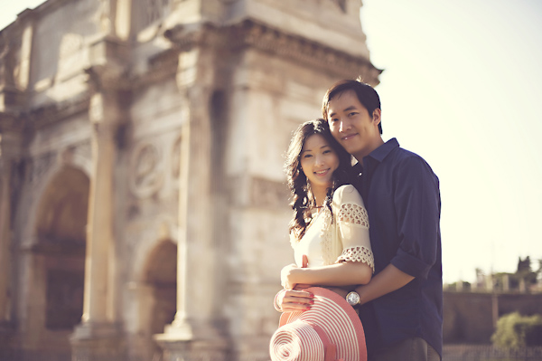 engaged couple standing beside historic building - engagement photo - wedding photo by top Rome based destination wedding photographer Rochelle Cheever, Rome Weddings Photography